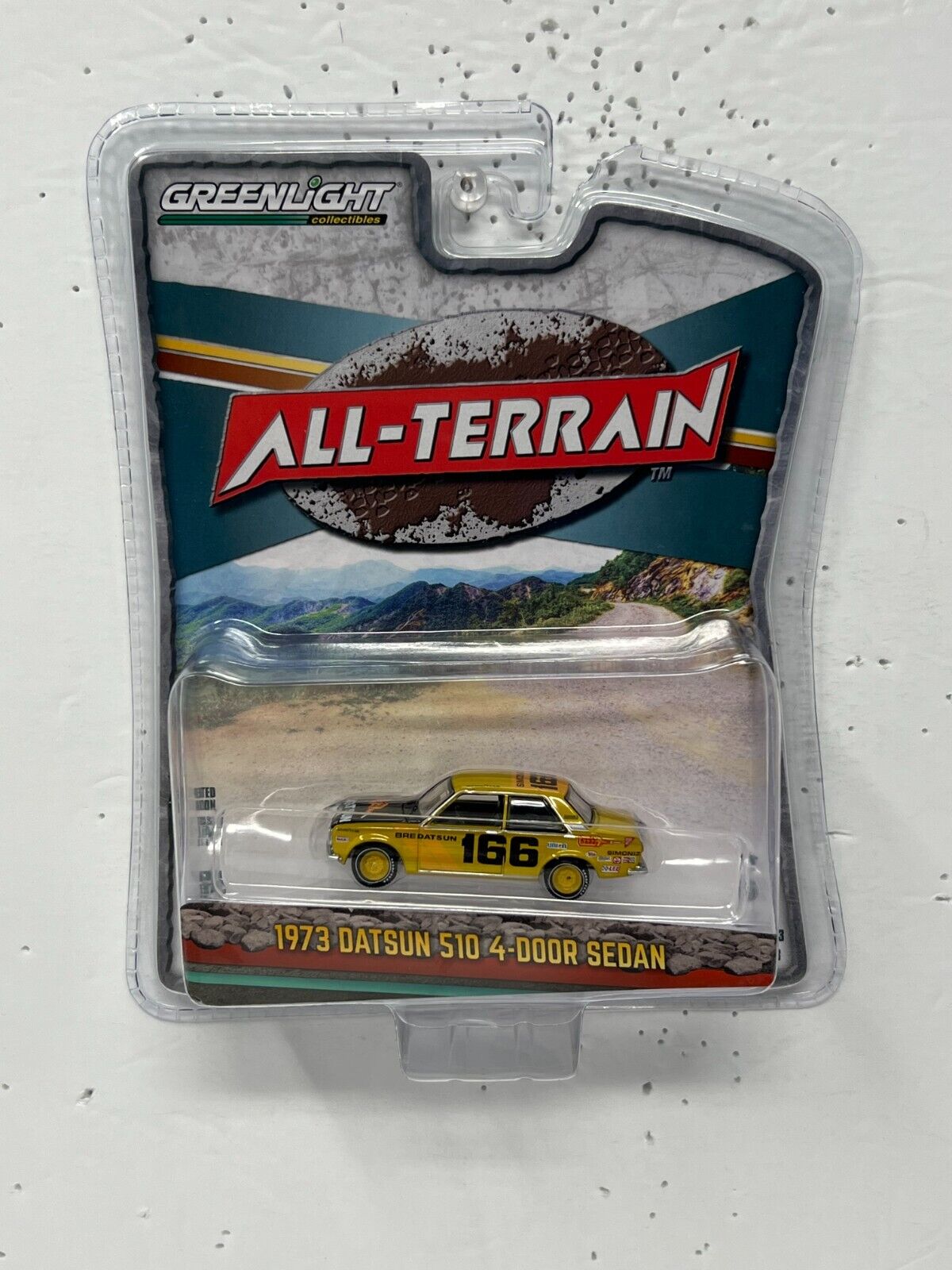 Greenlight All-Terrain 1973 Datsun 510 Sedan 4-Door 1:64 Diecast Version 2