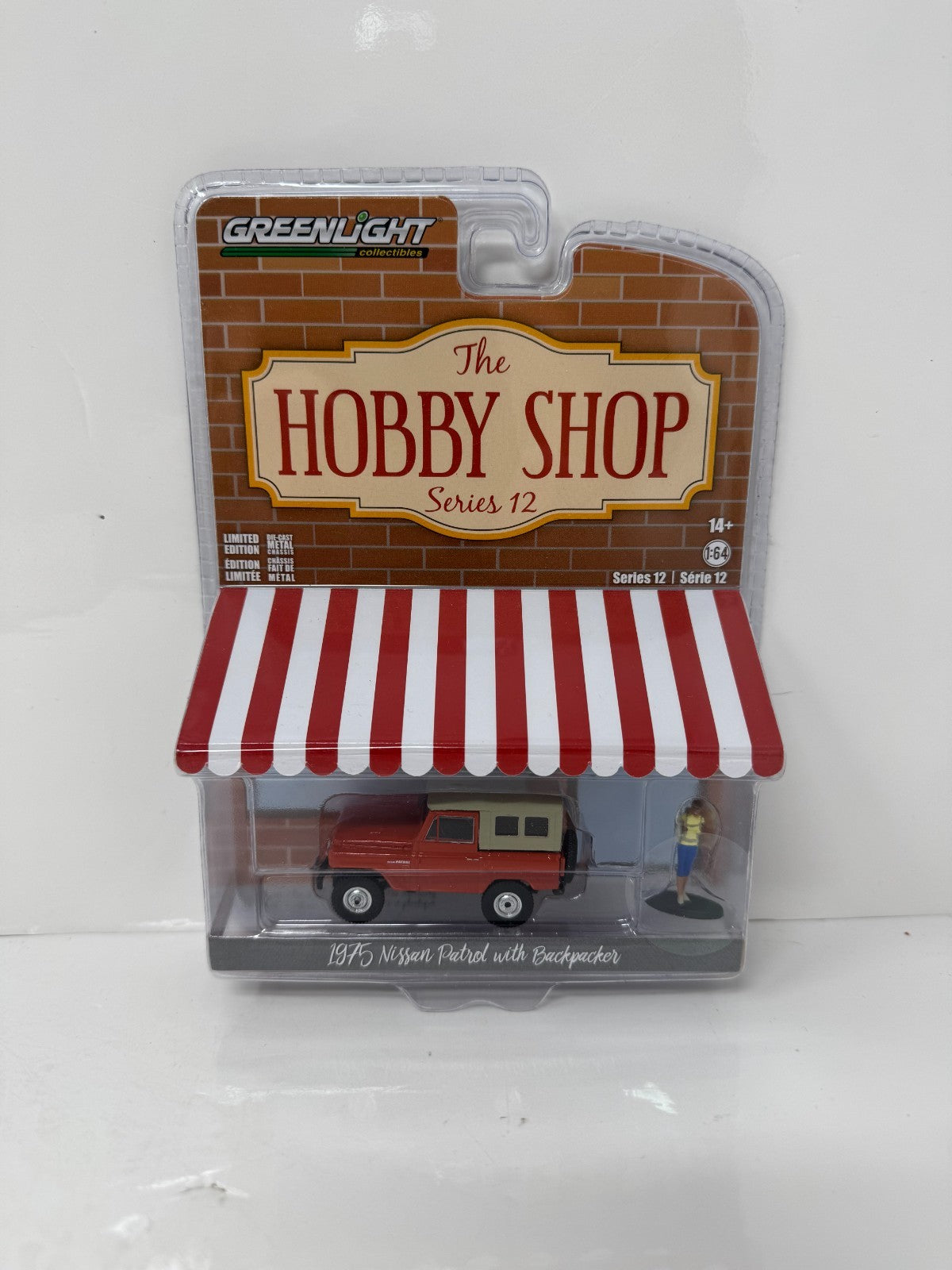 Greenlight The Hobby Shop 1975 Nissan Patrol with Backpacker 1:64 Diecast